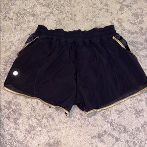 Black and gold lululemon shorts